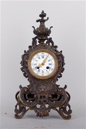 A bronze rococo style mantel clock. France, 19th century.43 x 23 cm.