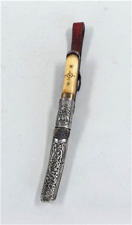 A Tibetan knife in Djokja silver, with a worked blade, also worked with...