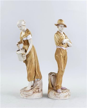 A pair of partly patinated Royal Dux figures, representing a farmer's wife...