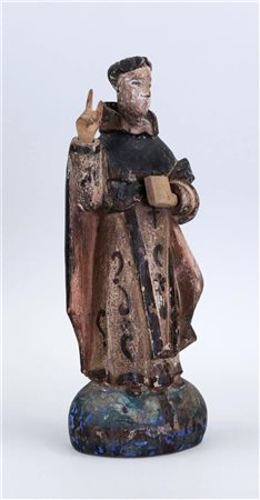 A polychrome statue of a saint depicting a Jesuit with a Bible, Philippines...