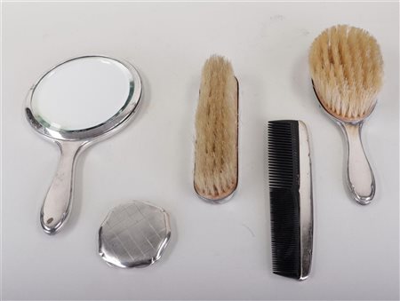 A silver hair set, including a silver powder box.