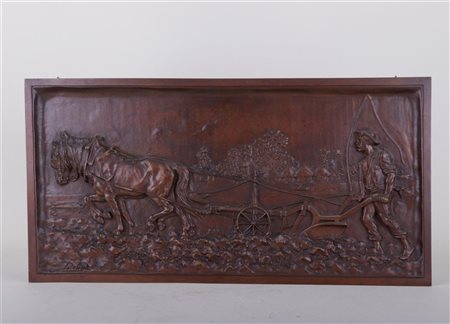 Marcel Début (1865-1933) A bronze plaque of a ploughing farmer, signed (in...