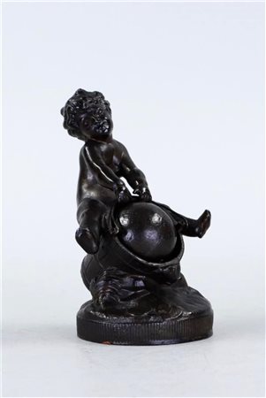 A patinated alloy statuette of a boy with a ball.H. 12 cm.