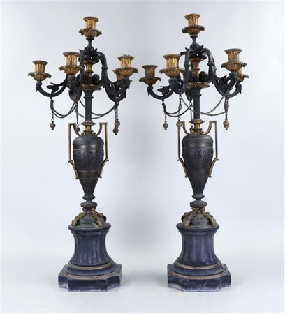 A pair of partly fire-gilded, six-armed bronze candlesticks, France 19th...