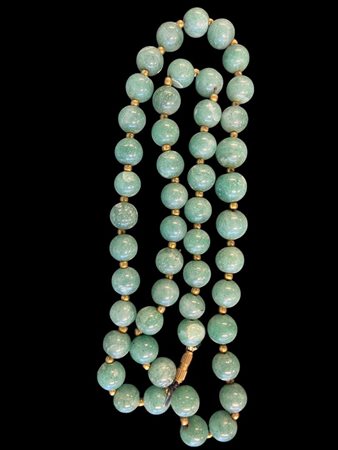 A green jade necklace. China, 20th century.