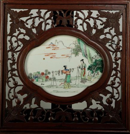 A porcelain famille vertre plaque with decoration of two ladies in a...