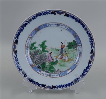 A porcelain doucai dish with various figures in a landscape. China, 18/19th...