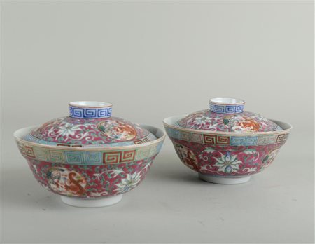 A set of porcelain famille rose lidded bowls with a decor of dragons and a...