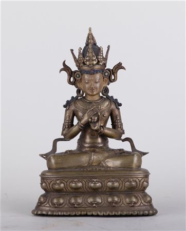 A bronze seated Buddha set with fantasy stones. Tibet, 18th/19th century. Remnants of polychrome. 