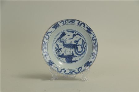 A small Ming dish with a representation of an abstracted bird in a landscape....