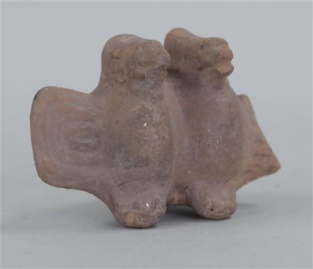 A terracotta flute in the shape of two birds. Mexico 800 BC.8 x 7 cm.