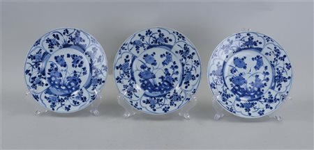 Three porcelain plates with floral decoration. China, Kangxi. ;Slight edge...