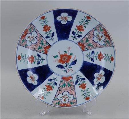 A large porcelain Imari dish with floral decoration in borders. China, 18th...