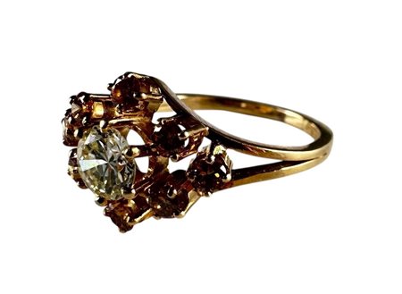 An 18kt yellow gold entourage ring set with diamonds. The ring is set with 1...