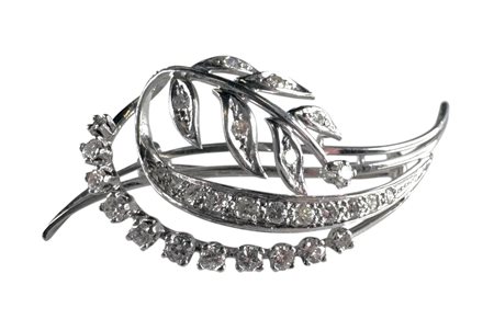 A 18kt white gold branch brooch set with 23 brilliant cut diamonds and 8...