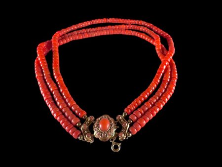 A beautiful strung blood coral necklace with a gold box clasp, set with...