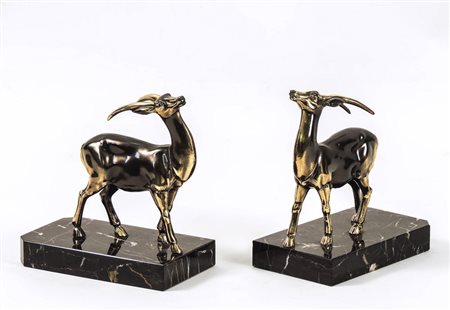 COPPIA DI FERMALIBRI IN METALLO PATINATO - PAIR OF PATINATED METAL BOOKENDS...