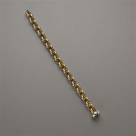 Bracciale rolò in oro giallo con chiusura in oro bianco, diamanti rotondi...