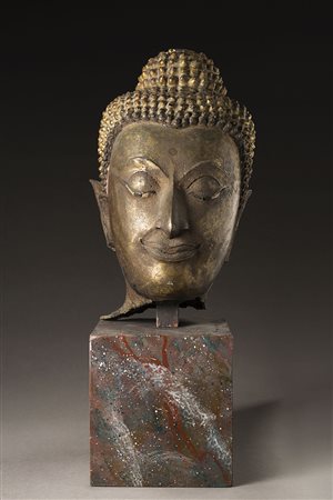 Testa di buddha in bronzo parzialmente dorato, base in pietra Sud-est asia,...