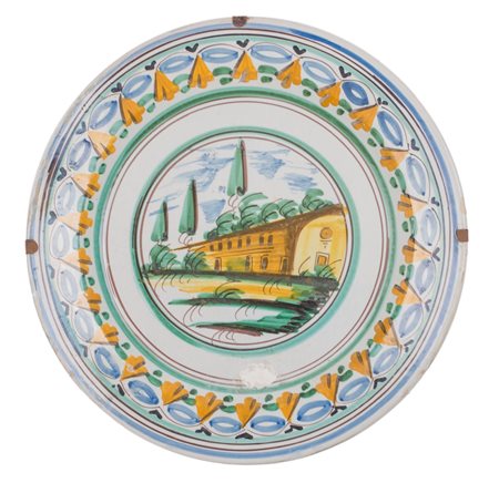 PIATTO in ceramica smaltata con medagline centrale raffigurante "paesaggio"....