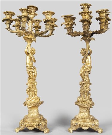 Coppia di candelabri a 7 luci in bronzo dorato raffiguranti putti, sec....