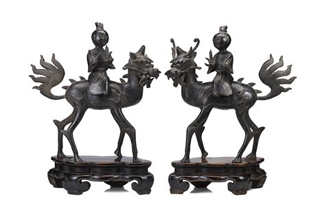 Coppia di bronzi raffiguranti fanciulli a dorso di qilin, indossano lunghe...